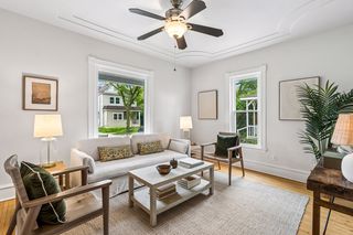 Living room with unique trayed ceilings and refinished hardwood floors faces south and west-golden hour glows await!