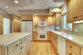 Softened millwork tones throughout form a light, airy and open Kitchen area.