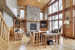 Built - in custom cabinetry, a field stone fireplace, natural plank wood flooring make this a showstopper.