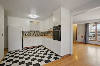 Kitchen with black and white tile flooring