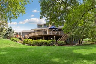 Outdoor deck and lower level patio look out on the private backyard