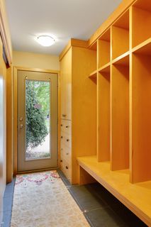 Mudroom entry from second door and 3 car garage with extensive storage.