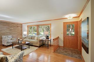 Living Room with large windows and brick accent wall