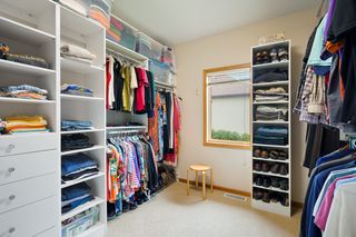 DREAM owner's suite walk-in closet/dressing area with custom built-ins. 