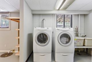 Laundry room with storage aplenty and an entrance to the  oversized two car garage and back yard.