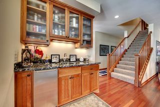 Mission style, custom cherry cabinetry with ribboned glass doors.