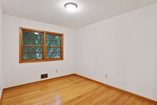 Bedroom Two is bright with a double window and natural wood floors.