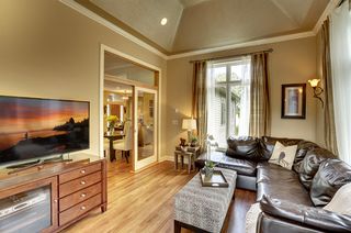 Even the porch has hardwood flooring and speakers in the vaulted metallic ceiling