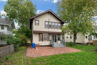 With a paver patio in the back and a front and side paver walkway