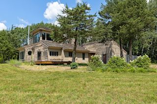 Rear exterior of home with heated indoor & outdoor dog run 