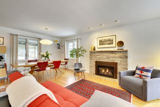 The Living Room & Dining Room feature Huge Windows & Hardwood Floors...