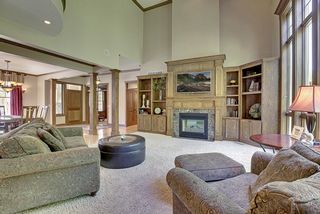 Custom built-ins frame the gas fireplace with stone surround.