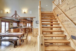 The open lodge-like stairway to the loft area has many special details: from the "pegged treads" to the special newel posts selected. The detailing is un-matched.