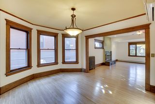 The Dining Room features Hardwood Floors & Large Bay Window.