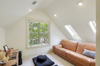 Lofted space with treetop views and two skylights to bring sunlight into a private space