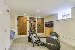 Non conforming lower level room for office, exercise and additional storage with a sleeping nook.