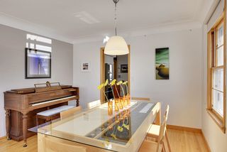 The Dining Room featured Coved Ceilings, Hardwood Floors & Pendant Light Fixture...