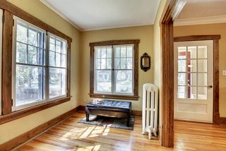 The Light-Filled Sunroom features gleaming Hardwood Floors! 