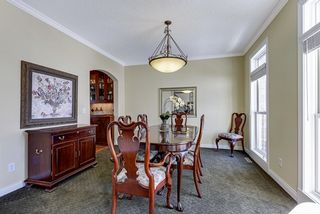 Elegant formal dining with double windows and a exquisite butler pantry