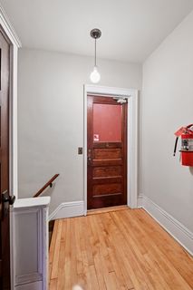 Upper-level front entry to Apt 3 & 4.
Features Hardwood flooring.