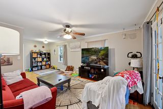 Living room features thermal pane windows and hardwood floors.
