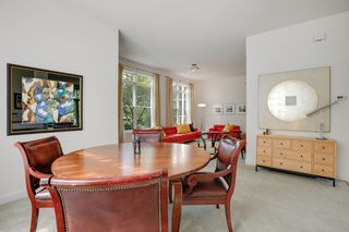 The Dining Room flows into the Living Room with a wall of south-facing windows