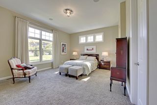 The large master bedroom features carpet, large picture windows, and an abundance of square footage.