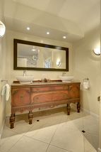 The Custom 2nd Floor Bathroom features an Antique Vanity with Double Vessel Sinks! 