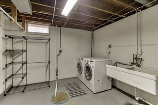Laundry room has natural light, newer washer dryer and laundry sink.