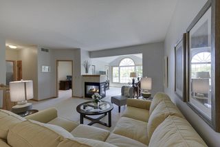 Double-sided fireplace separates living room from four season sun porch...