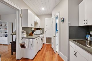 Another View of Kitchen in Apt #3.
Features Hardwood floors, newer thermal pane vinyl windows, newer appliances, Shiplap Ceiling and lighting.
Bathroom door from kitchen.