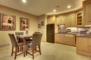 Lower level wet bar with granite counter tops and slate back splash