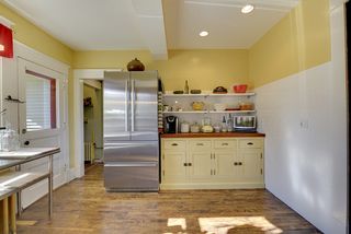 The Kitchen features Hardwood Floors, High-End Stainless Liebherr Refrigerator, WOLF Range & Custom Cabinets! 