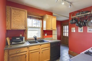 kitchen with gas stove and dishwasher, tiled floors and access to the back deck with grill