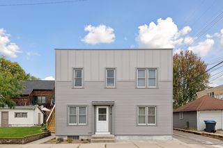 Front view of 4 plex features all new Vinyl and Wood Siding, new Vinyl Window Wrap. New Vinyl Windows 2023 throughout. New Exterior Staircase that leads to apt #4 also has new Vinyl Windows. New Storm Doors on 3 entrances.