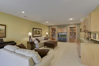 Open family room with wet bar and built-in bookshelves...
