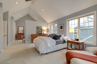 Master bedroom is a terrific retreat with vaulted ceilings and large windows. The separate dressing area has two closets and room for dressers