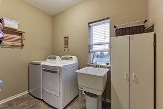 Main floor laundry with laundry sink. Natural light from the window with views of the back yard
