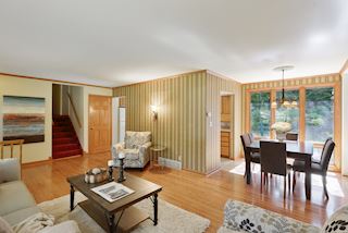 Dining room with floor to ceiling windows to capture the back yard with decks