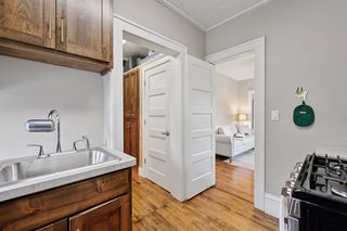 Another View of Kitchen in Apt #4.
Features Custom Birch Cabinets, Stainless Steel Appliances, Custom Stained Hardwood floors, Shiplap Ceiling and Lighting.
Doorways to Living room and Bathroom and Large closet and storage space.