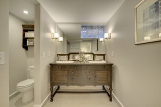 Double sinks - antique vanity, mirrored wall. 