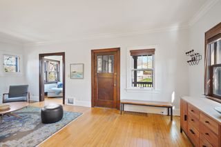 Light filled main floor beautiful hardwood floors, walls of windows  and open Living Room, Dining Room and Sun Room