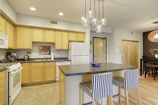 The Kitchen features a Gas Stove, Center Island & unique Light Fixture...