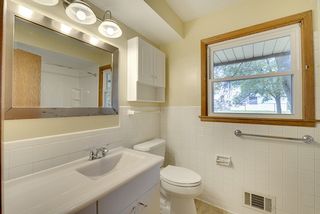Newer vanity top, tub, toilet, shelving, lighting, faucet and floor. 