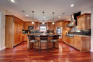 Large, spacious kitchen, Cherry custom built cabinetry, custom built island, granite countertops and backsplash.