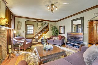 Entertain in style! The gracious Living Room features Rich Original Woodwork and Original Light Fixtures.