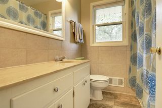 Mainfloor full bath with updated flooring and Ceramic tile surround
