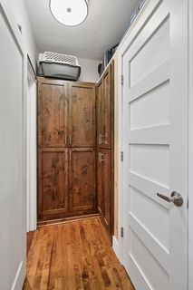 View of Large closet and storage space.
Features Custom matching Cabinetry and Custom Stained Hardwood Flooring.