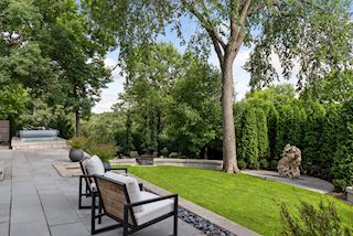 Beautifully private, mature and manicured yard for your very own serene getaway with blue slate decking