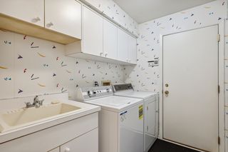 Laundry room with a walk-in closet and a silver closet.